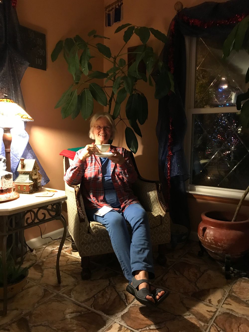 Lady sitting in conservatory at the Little English Gueshtouse Bed and Breakfast Tallahassee Florida.