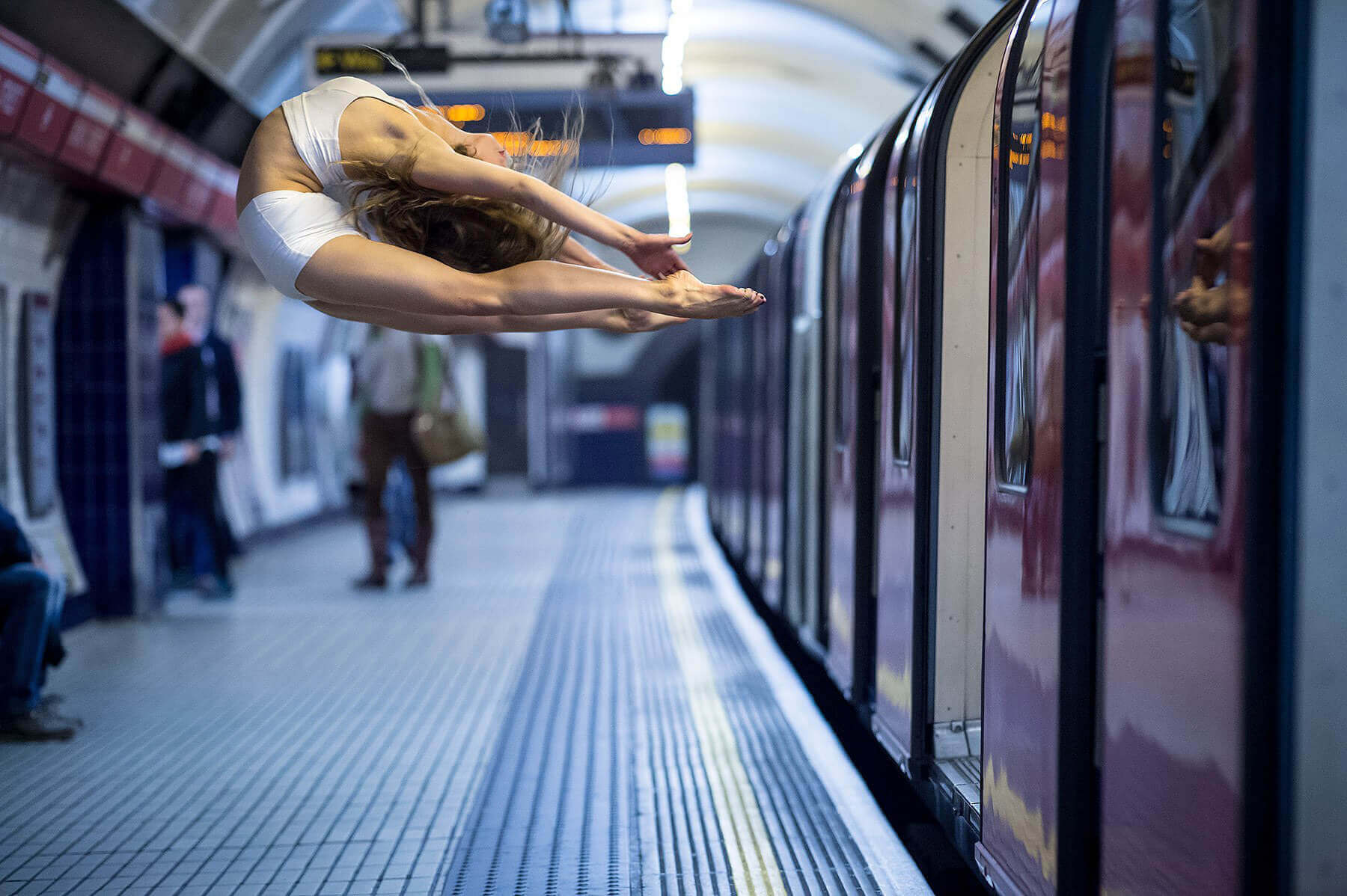 Dancer leaping off a London Underground carriage