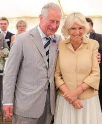 Camilla, Duchess of Cornwall smiling with Prince Charles