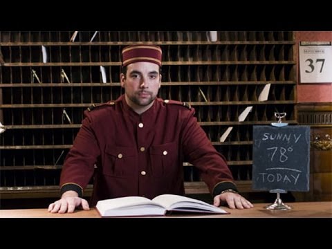 Uniformed hotel receptionist glaring