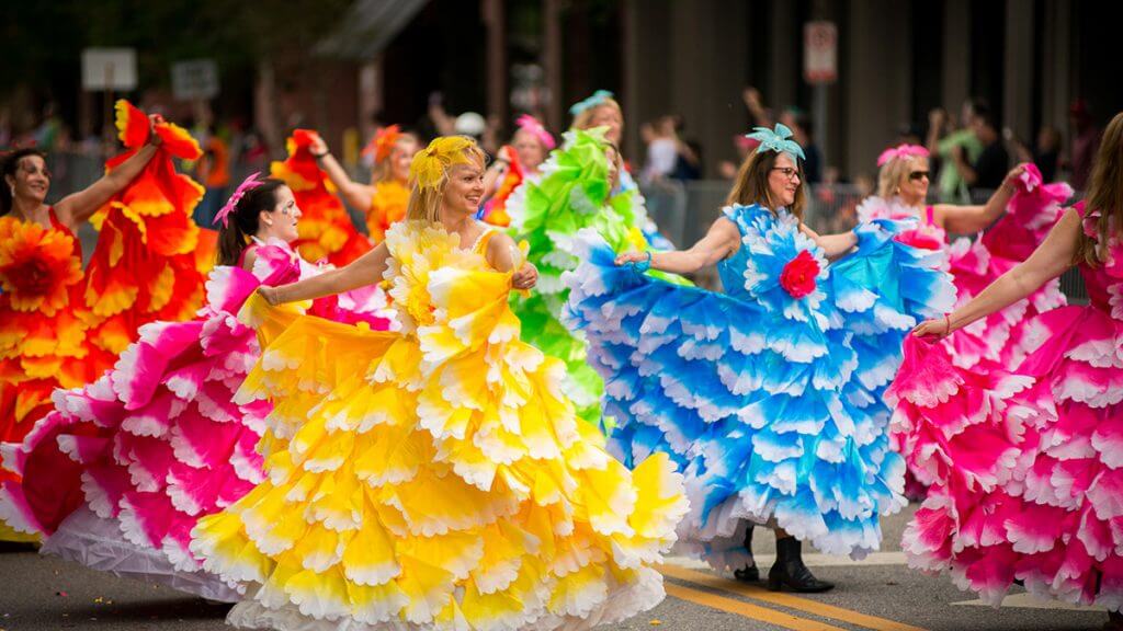 Ladies dressed in brightly colored ruffled dresses in Tallahassee parade